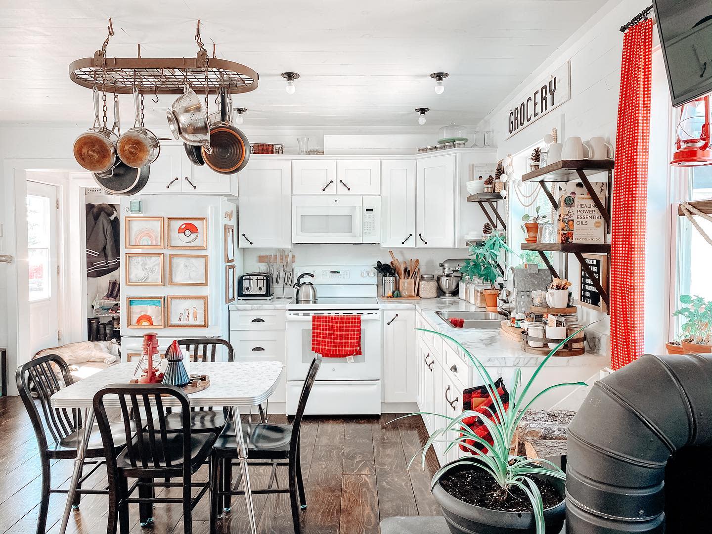 colorful rustic kitchen vintage table black chairs hanging roof pots 